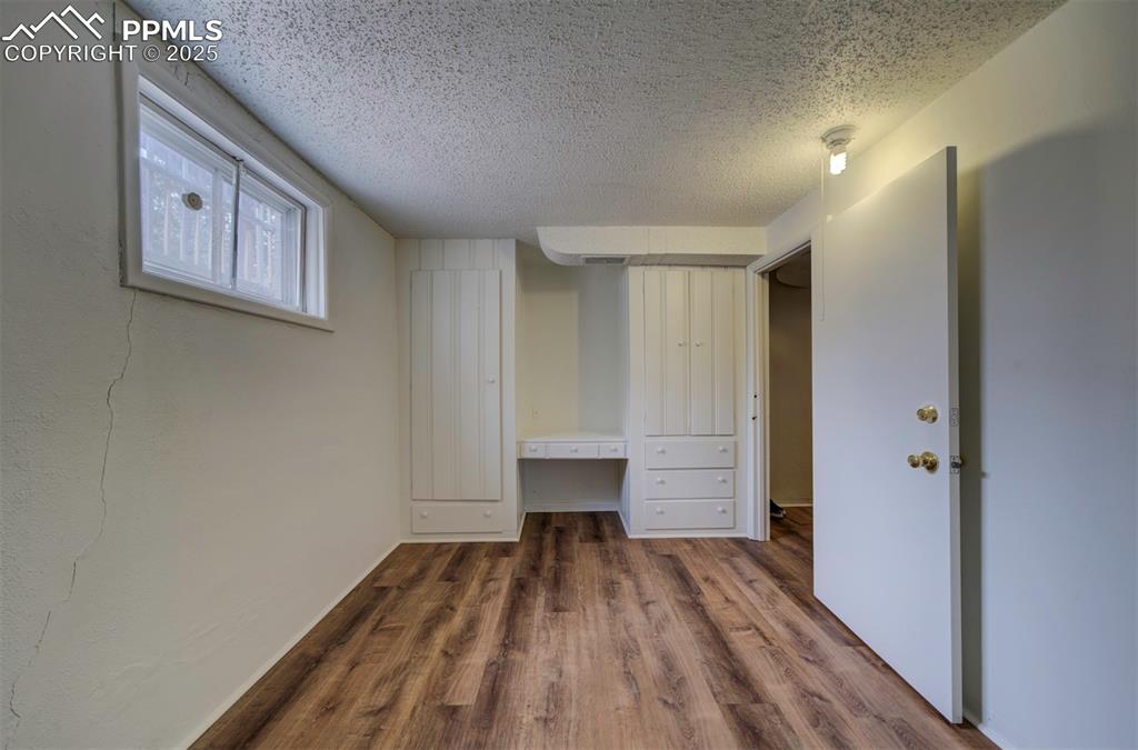 130 Cresta Road Colorado Springs, CO 80906 - Photo 40 of 49 a view of a room with wooden floor staircase and a hallway