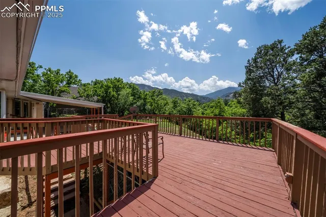 a balcony with wooden floor and city view