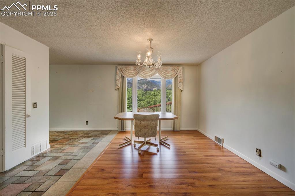 130 Cresta Road Colorado Springs, CO 80906 - Photo 8 of 49 a view of an empty room with window wooden floor and a yard