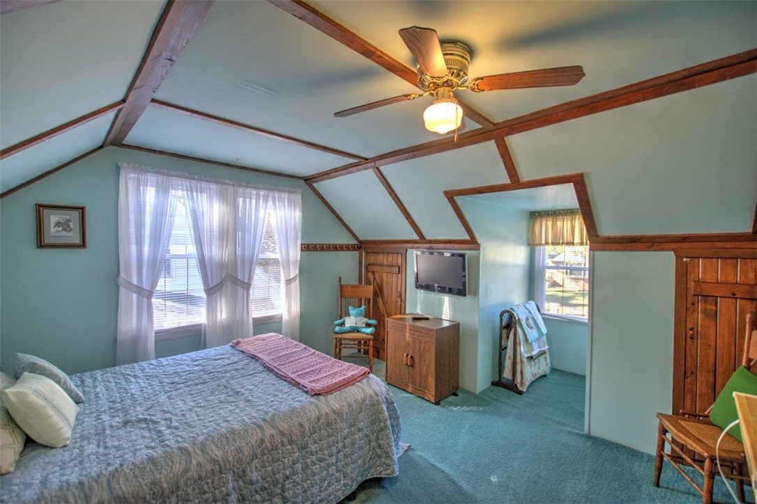 1677 West Sunset Avenue Decatur, IL 62522 - Photo 20 of 32 a bedroom with a bed and a large mirror with a chandelier