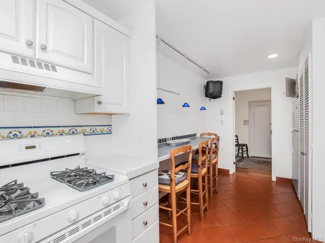 a kitchen with granite countertop cabinets and white appliances
