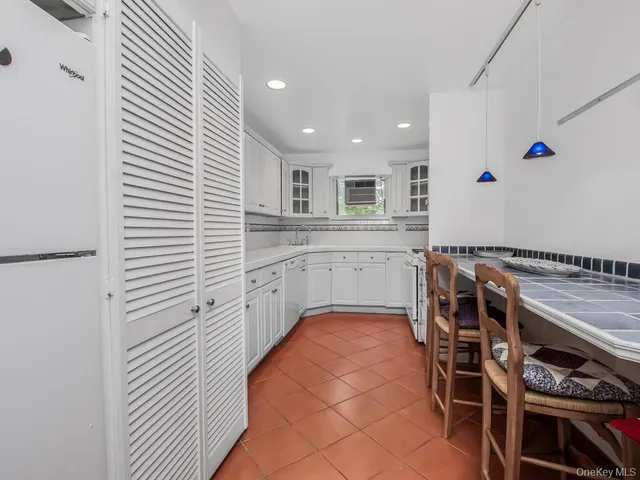 a kitchen with stainless steel appliances a sink and a refrigerator