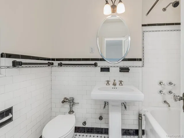 a bathroom with a sink toilet and a mirror