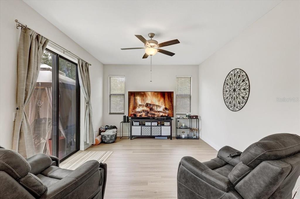 7314 Madrid Road Weeki Wachee, FL 34613 - Photo 11 of 54 a living room with furniture and a flat screen tv