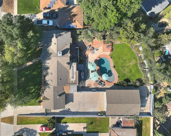 an aerial view of residential houses with outdoor space