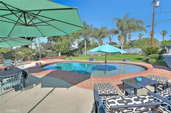a view of a backyard with sitting area