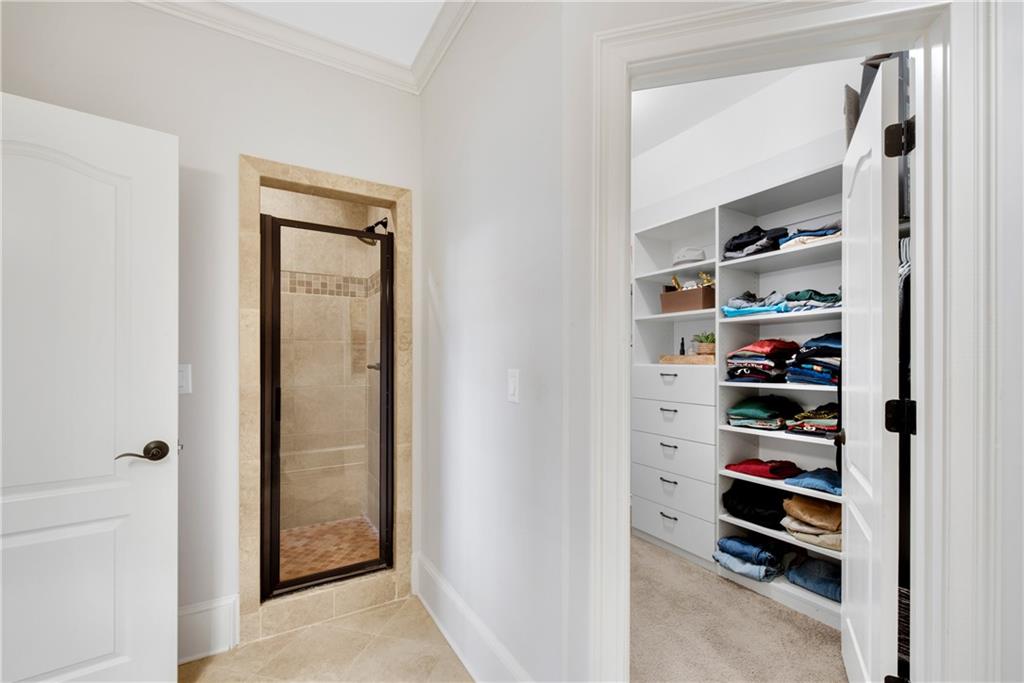 13942 Tree Loft Road Milton, GA 30004 - Photo 60 of 102 a view of walk in closet with clothes and shoes