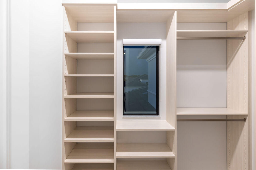 2740 Northwest 69th Street Boca Raton, FL 33496 - Photo 44 of 79 a view of walk in closet with empty racks