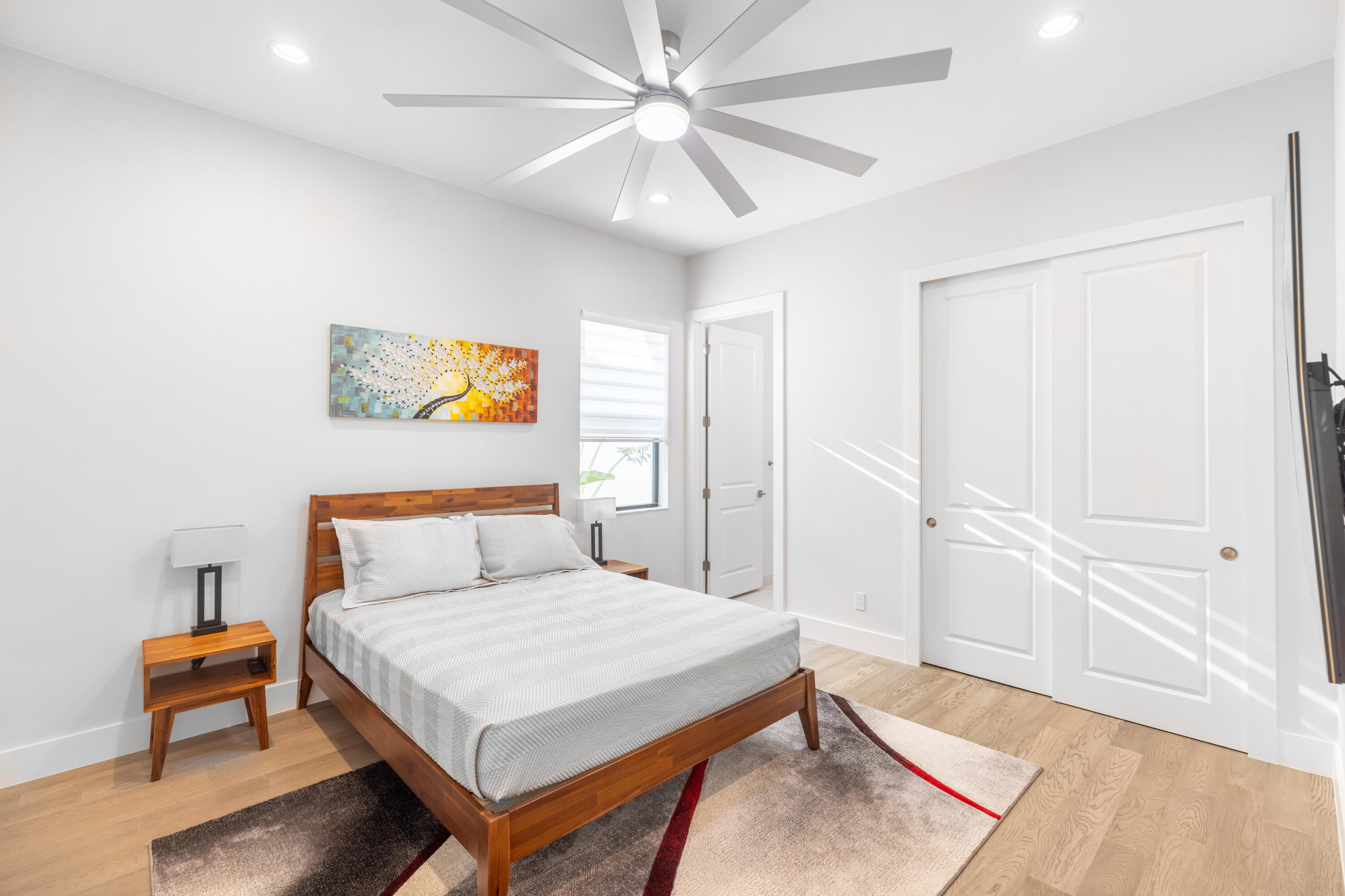 2740 Northwest 69th Street Boca Raton, FL 33496 - Photo 45 of 79 a bedroom with a bed and a table in it