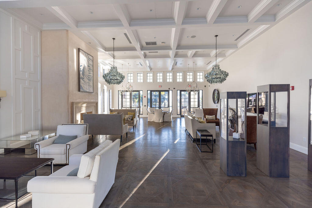2740 Northwest 69th Street Boca Raton, FL 33496 - Photo 67 of 79 a dining room with wooden floor furniture and a chandelier