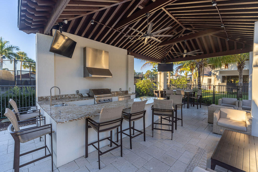 2740 Northwest 69th Street Boca Raton, FL 33496 - Photo 70 of 79 a patio with a table and chairs