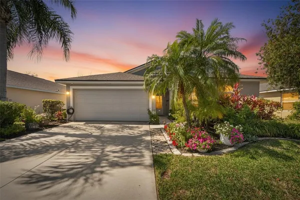 a front view of a house with a yard and a garage