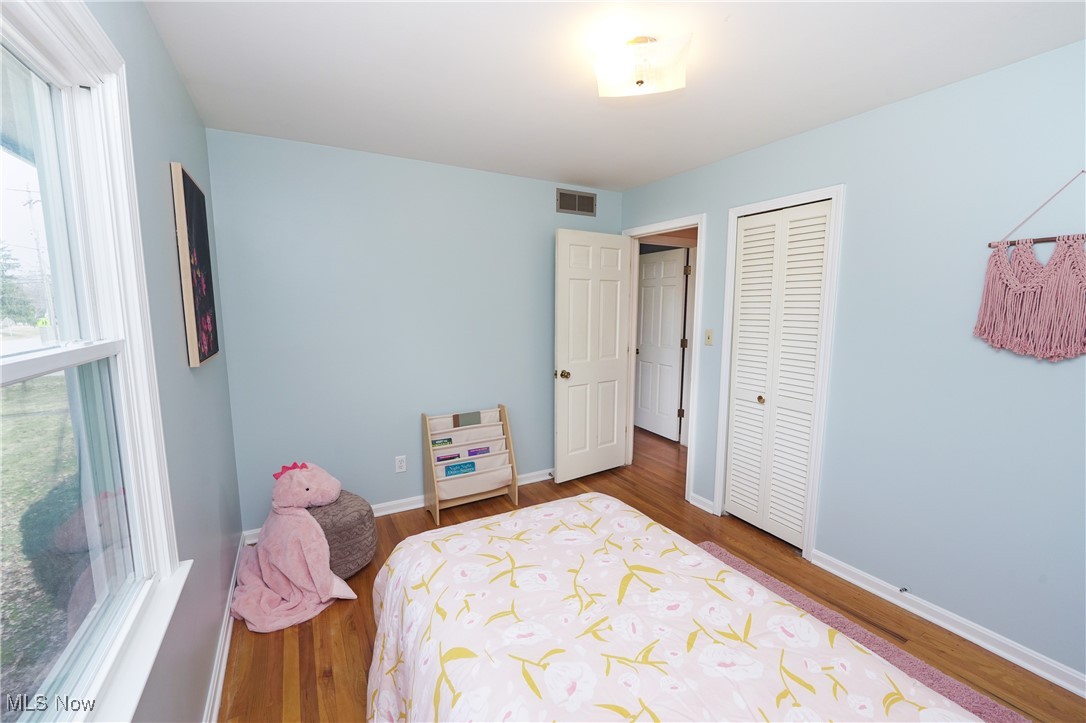 2674 Smith Road Fairlawn, OH 44333 - Photo 22 of 31 Bedroom featuring baseboards, a closet, visible vents, and wood finished floors