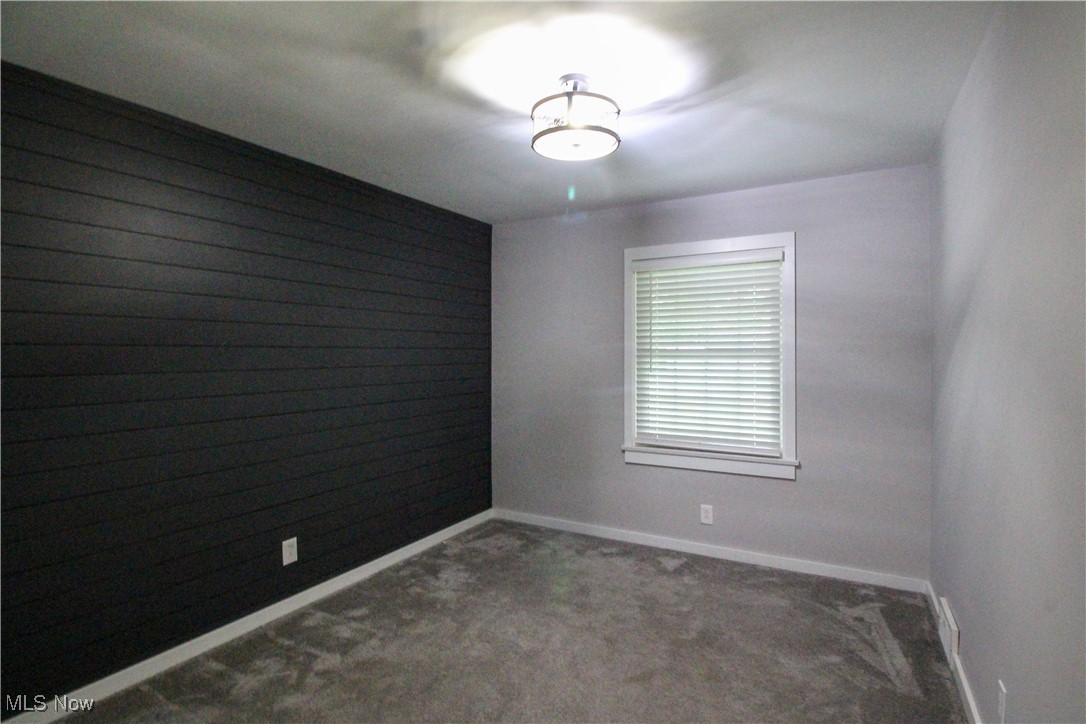 207 Harmon Road Aurora, OH 44202 - Photo 23 of 40 Office with accent wall and neutral colored carpet.