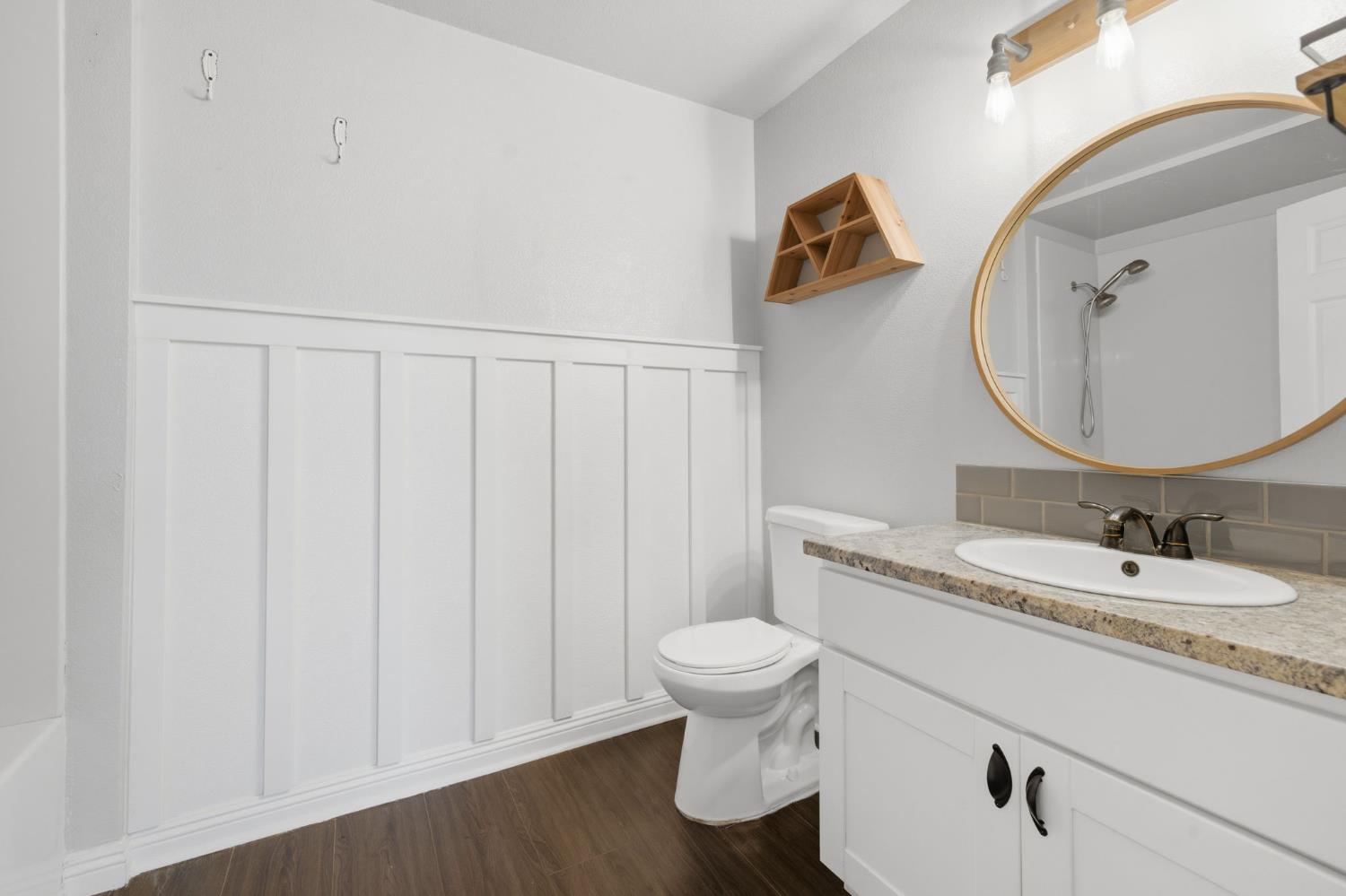 7580 Latrobe Road Shingle Springs, CA 95682 - Photo 12 of 56 a bathroom with a toilet sink vanity and mirror