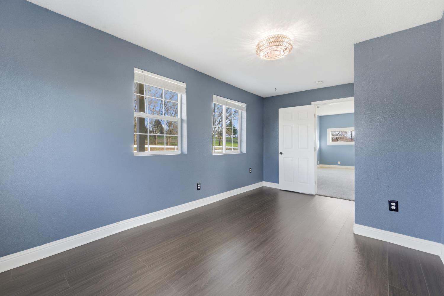7580 Latrobe Road Shingle Springs, CA 95682 - Photo 17 of 56 a view of an empty room with wooden floor and a window