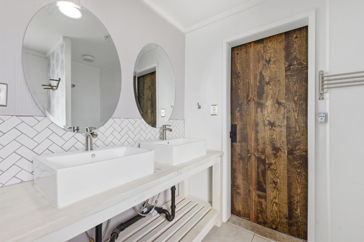 7580 Latrobe Road Shingle Springs, CA 95682 - Photo 21 of 56 a bathroom with a double vanity sink and a mirror