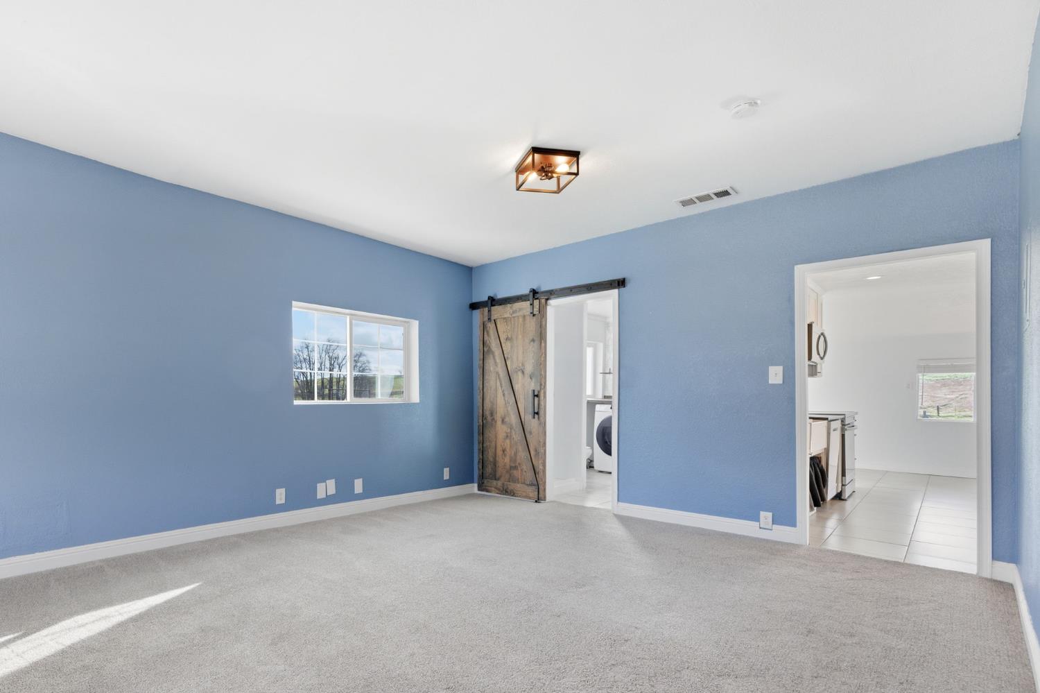 7580 Latrobe Road Shingle Springs, CA 95682 - Photo 30 of 56 an empty room with closet and windows