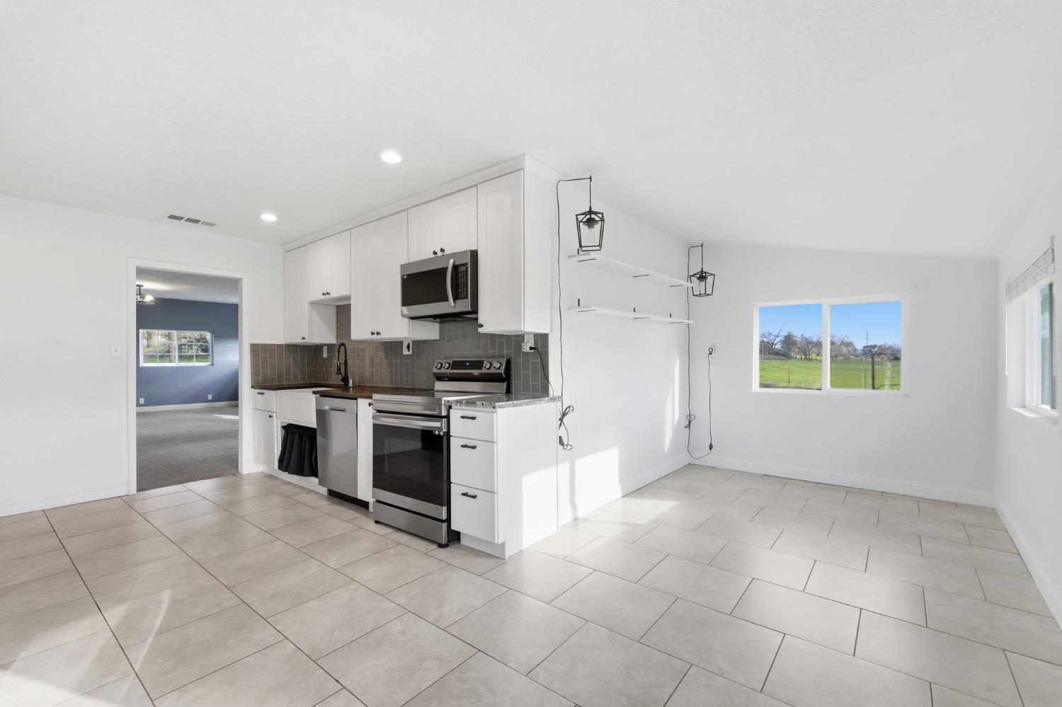 7580 Latrobe Road Shingle Springs, CA 95682 - Photo 8 of 56 a kitchen with a stove a sink and a refrigerator