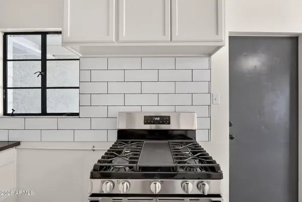 a kitchen with a stove and a refrigerator