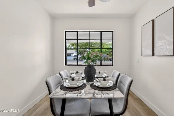 a kitchen with stainless steel appliances a sink cabinets and a wooden floor