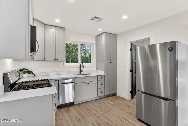 a kitchen with stainless steel appliances a stove a microwave and cabinets