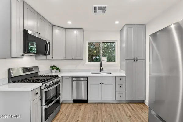 a stove top oven sitting inside of a kitchen