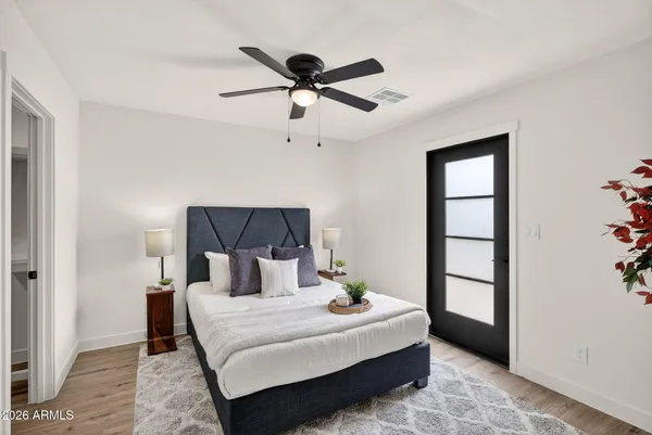 a bedroom with a bed and a chandelier