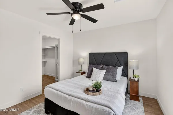 a bathroom with a granite countertop sink toilet and a mirror