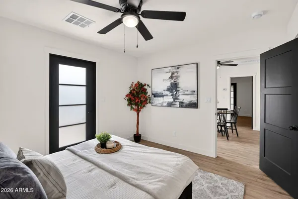 a bedroom with bed and wooden floor