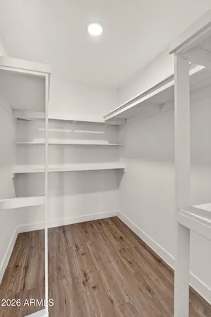 an empty room with windows and ceiling fan