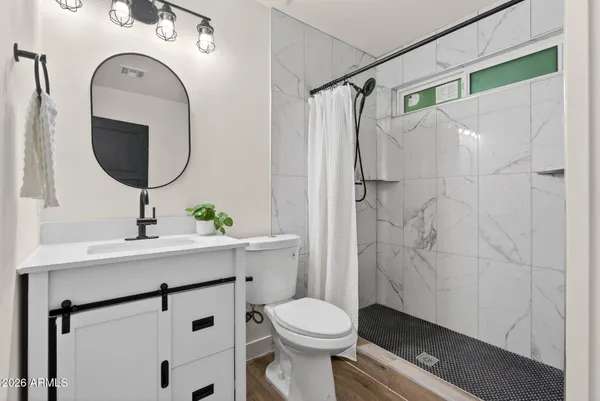 a view of a house with a yard and a tree