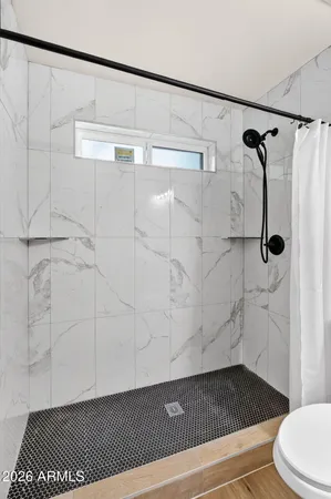 a view of a white house with a yard and large tree