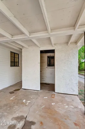 a view of a terrace with lawn chairs