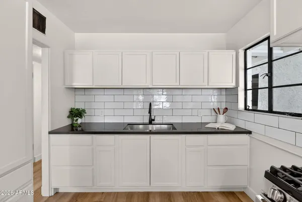 a stove top oven sitting inside of a kitchen