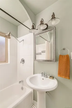 a bathroom with a sink a mirror and a bathtub