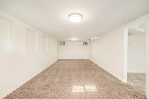 an empty room with windows and entrance