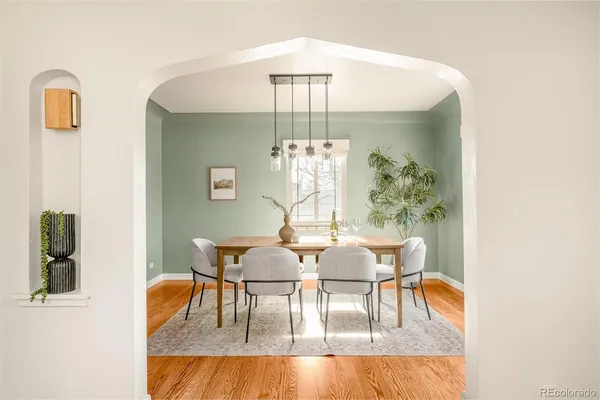 a view of a dining room with furniture and chandelier