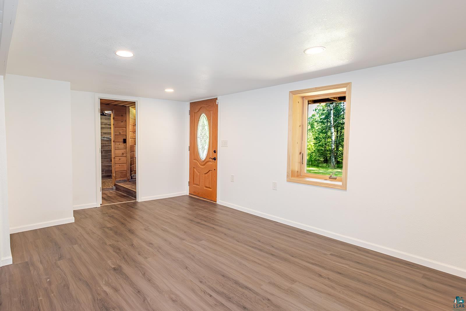 29 Ridge Road Esko, MN 55733 - Photo 33 of 41 Spacious room featuring wood-finish flooring, white walls, and recessed lighting