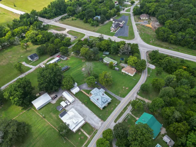 an aerial view of residential houses with outdoor space and street view