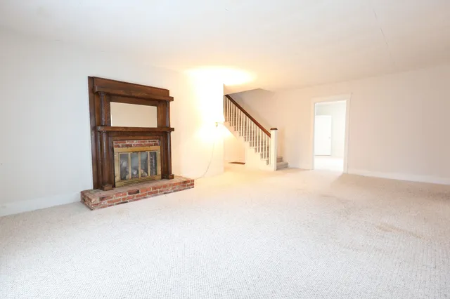 a view of an empty room with a fireplace