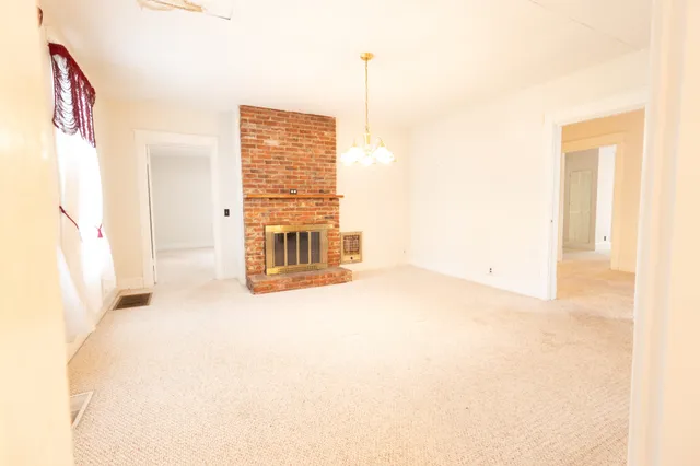 a view of an empty room with a fireplace