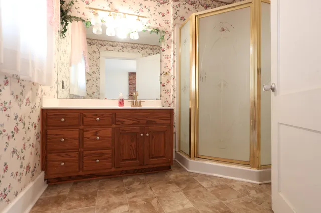 a bathroom with a sink a toilet and a mirror