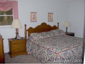 34 Westfield Road Fletcher, NC 28732 - Photo 11 of 12 a bedroom with a bed and a lamp on table