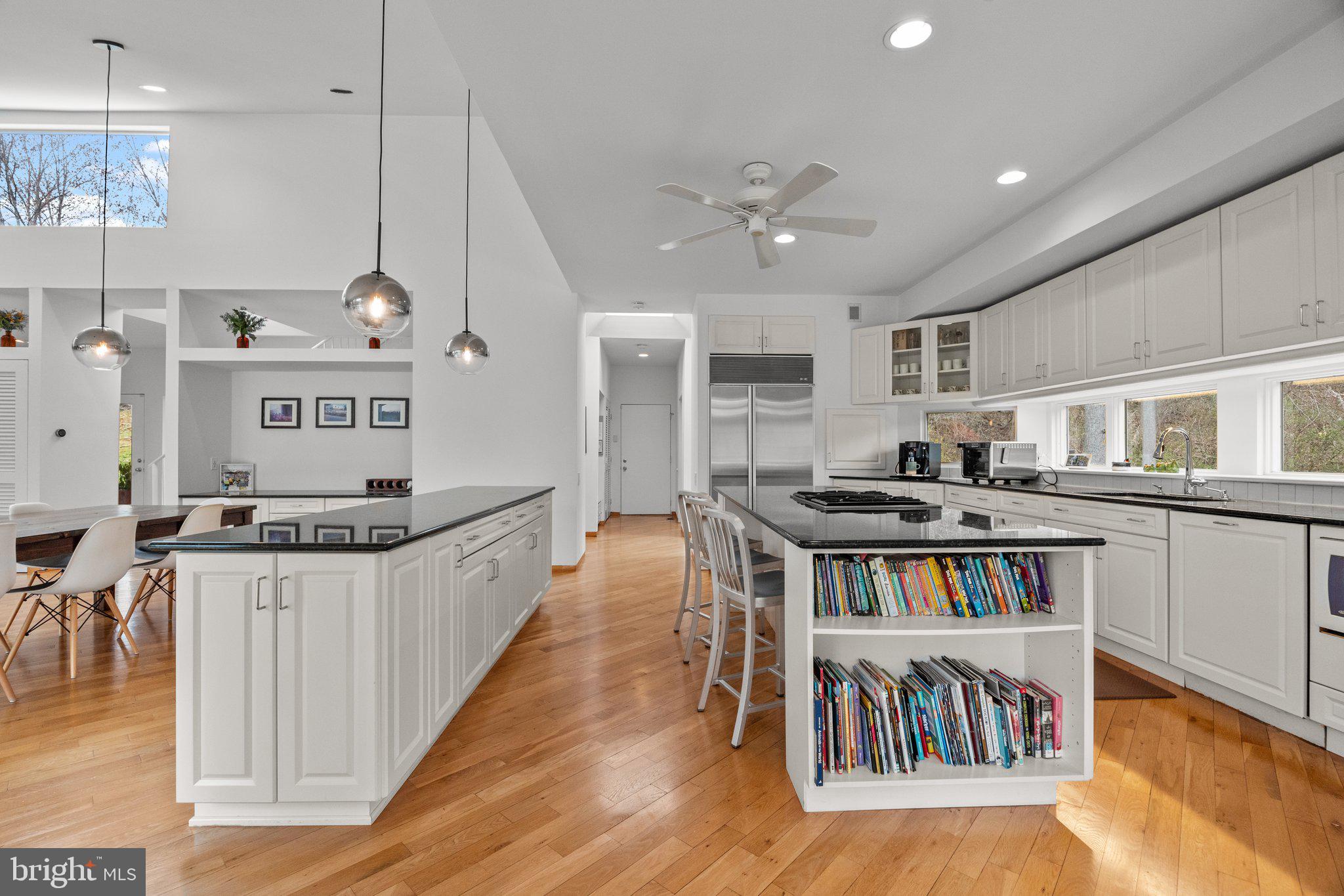 1223 Old Ford Road Huntingdon Valley, PA 19006 - Photo 11 of 36 a kitchen with stainless steel appliances granite countertop a stove a sink dishwasher and a dining table with wooden floor