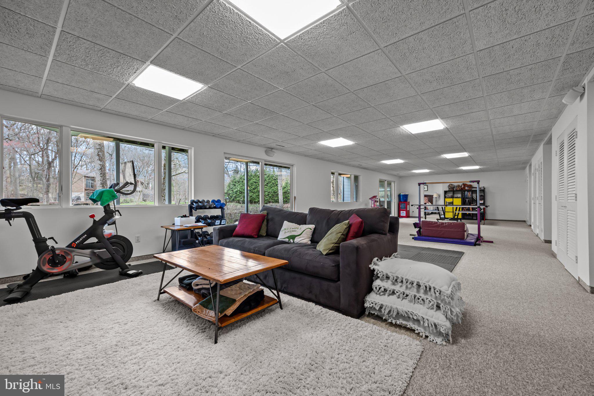 1223 Old Ford Road Huntingdon Valley, PA 19006 - Photo 19 of 36 a living room with furniture gym equipment and a large window