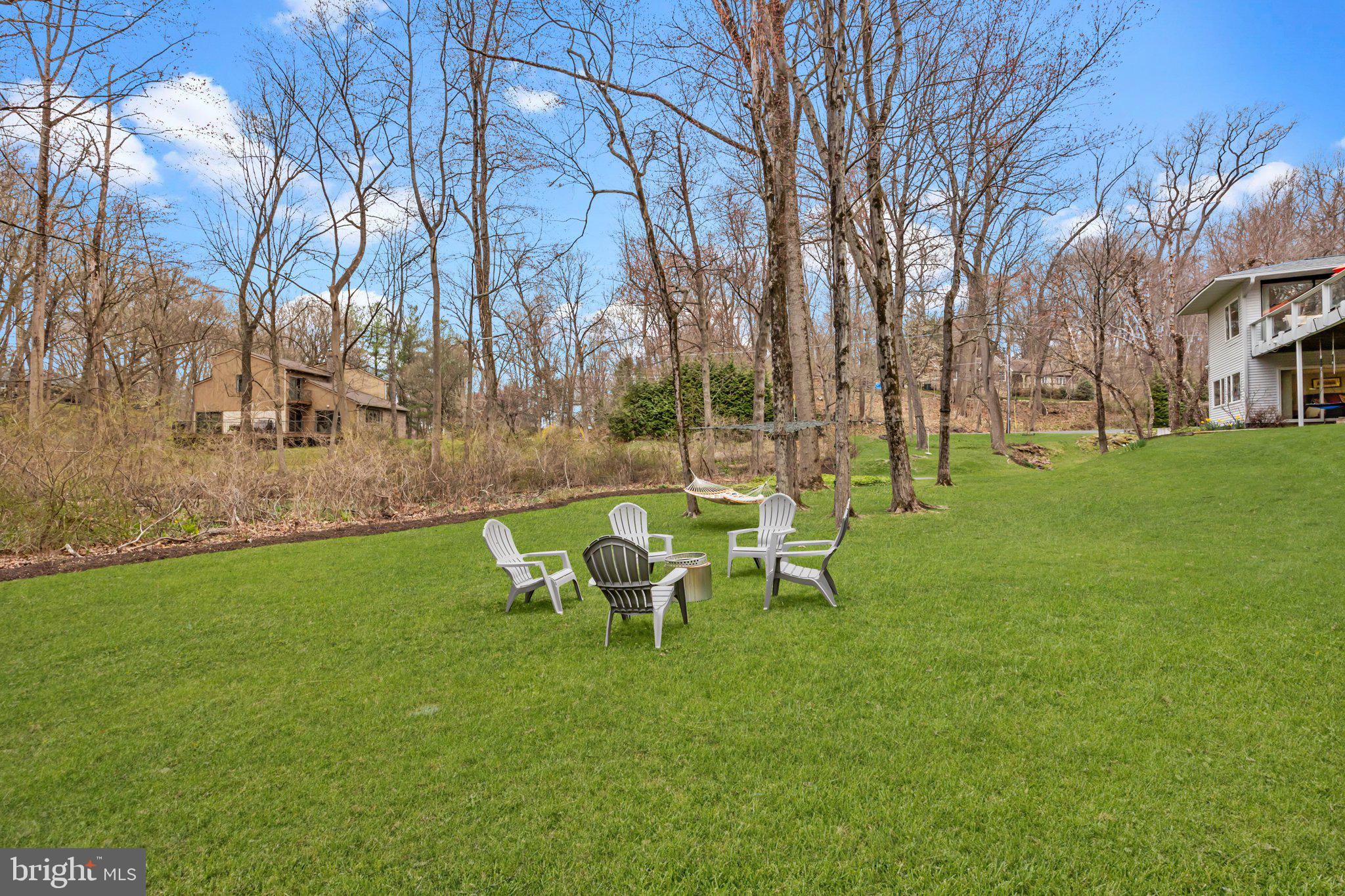 1223 Old Ford Road Huntingdon Valley, PA 19006 - Photo 30 of 36 a view of a backyard with table and chairs and a fire pit