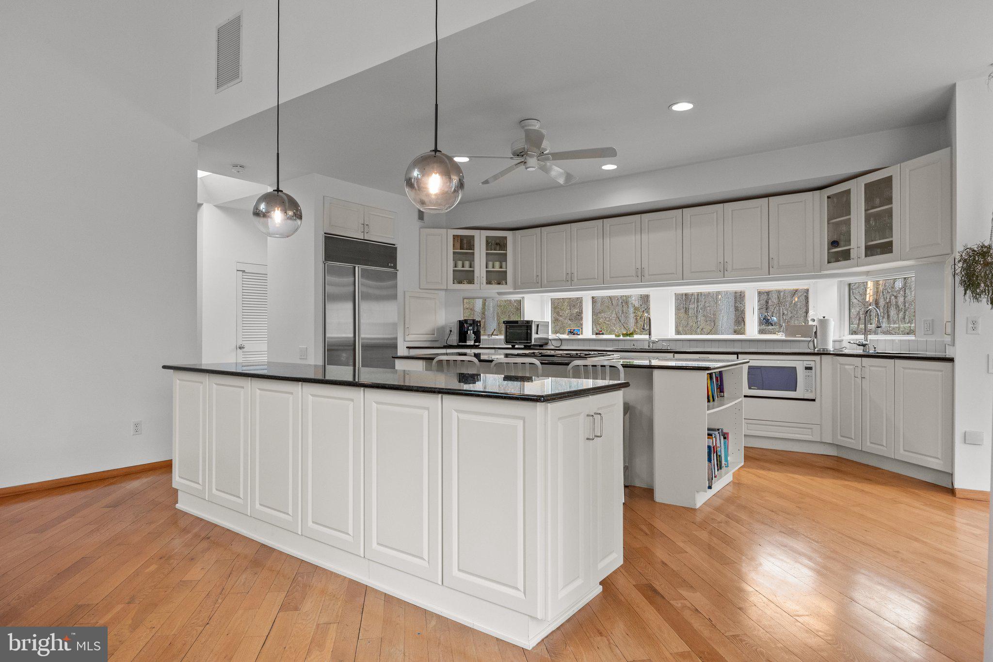 1223 Old Ford Road Huntingdon Valley, PA 19006 - Photo 9 of 36 a kitchen with stainless steel appliances granite countertop a sink a stove a refrigerator cabinets and wooden floor