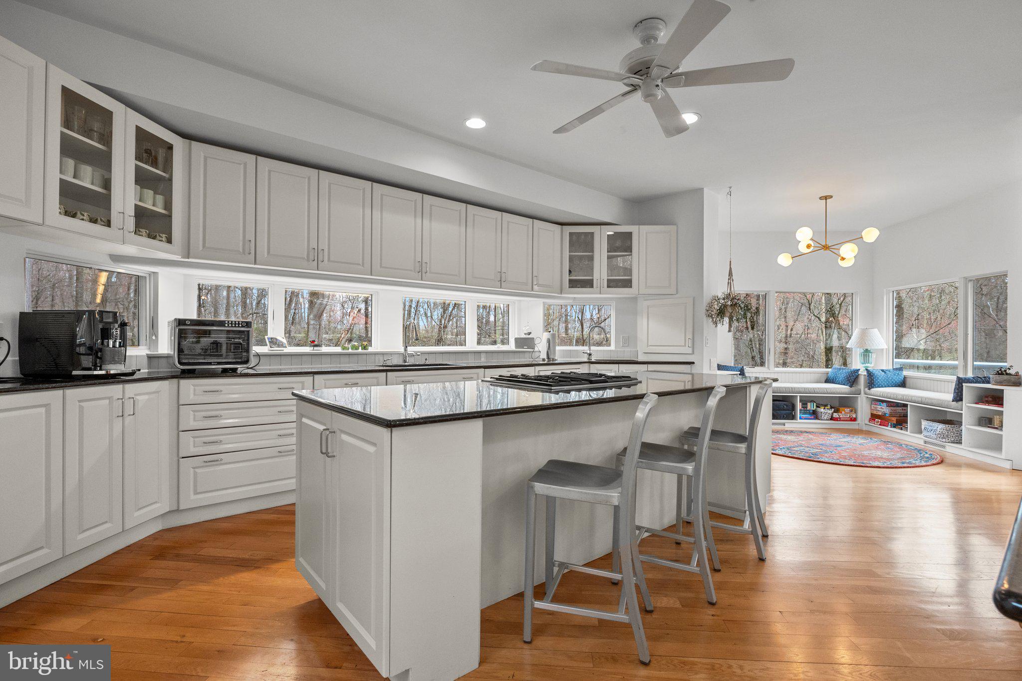 1223 Old Ford Road Huntingdon Valley, PA 19006 - Photo 10 of 36 a kitchen with stainless steel appliances granite countertop a stove top oven a sink a dining table and chairs with wooden floor