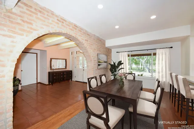 a view of a a dining room with furniture window and wooden floor